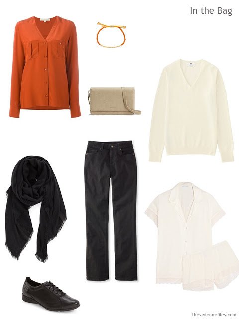 a travel outfit in orange, black, and sand