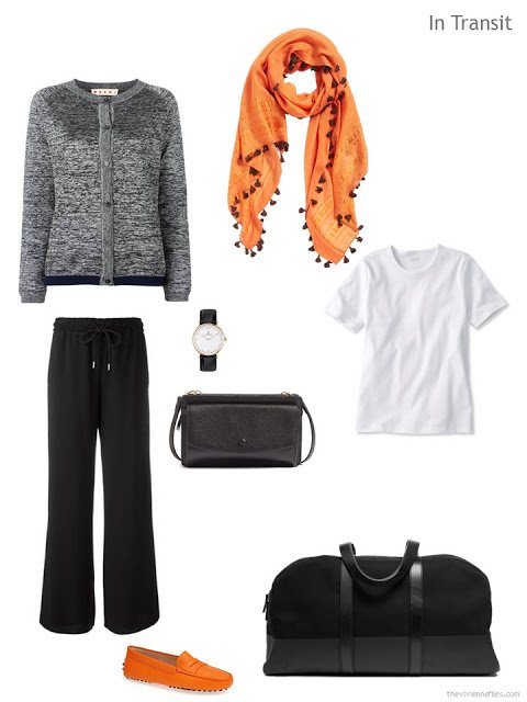 travel outfit in black and white with orange accents